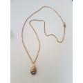 Delicate gold tone fashion necklace with natural lava rock copper wire wrapped pendant