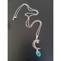 Silver tone fashion necklace with moon & star pendant with unusual blue bead