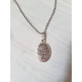 Silver tone fashion necklace with the tree of life oval pendant