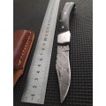 Handmade Damascus steel folding knife with Wooden handle scales.