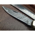 Handmade Damascus steel folding knife with Bull Horn handle scales.