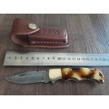 Handmade Damascus steel folding knife with Burnt Camel Bone handle scales.