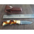 Handmade Damascus steel folding knife with Burnt Camel Bone handle scales.
