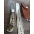 Handmade Damascus steel folding knife with RAM HORN handle scales.