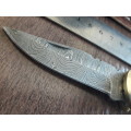 Handmade Damascus steel folding knife with Camel Bone handle scales.