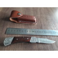 Handmade Damascus steel folding knife with Wooden handle scales.