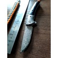 Damascus VG-10 Stainless Steel folding knife, RAZOR Sharp, EBONY handle scales, bolster engraved.