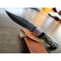 Handmade Damascus steel folding knife with Bull Horn Handle. Art engraved.