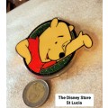Poo Bear Pin back says  Disney Store St Lucia