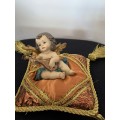 CHERUB PLAYING THE MANDOLIN SITTING ON GOLD BRAIDED CUSHION