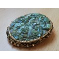 Vintage gold coloured brooch with green semi-precious stones