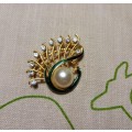 Gold-coloured vintage brooch with green inlay and diamante detail