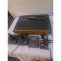 VINTAGE ATARI VIDEO COMPUTER SYSTEM WITH A GAME CARTRIDGE AND ASSESCORIES