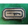SADF PERIOD MARKSMAN BADGE NUTRIA BACKING WITH BLACK EMBROIDERED BORDER
