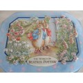 A COLLECTABLE BENTLEY'S OF LONDON TIN WITH RAISED RELIEF DESIGN - THE WORLD OF BEATRIX POTTER