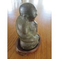 AN ANTIQUE CHINESE HOLLOW CAST BRONZE FIGURE OF SEATED BUDDHA