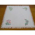 A HAND EMBROIDERED TRAY CLOTH WITH DISA LILY DESIGN