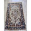 A BEAUTIFUL VINTAGE WOVEN RUG WITH BIRD AND FLORAL DESIGN (160CM X 96CM) AND INTERESTING HISTORY