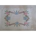 A PRETTY HAND EMBROIDERED RECTANGULAR CLOTH WITH SPRAYS OF PINK AND BLUE FLOWERS