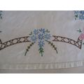 A PRETTY HAND EMBROIDERED RECTANGULAR CLOTH WITH SPRAYS OF PINK AND BLUE FLOWERS