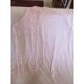 A DELICATE, FEMININE POWDER PINK SHAWL WITH LONG TASSELS AND SILVER STRANDS