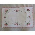 A CHEERFUL EMBROIDERED CLOTH WITH BERRIES AND SCALLOPED BORDER
