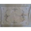 Two rectangular embroidered tray cloths