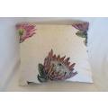 A small cushion with pretty proteas