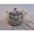 A pretty oriental teapot with floral and bird design