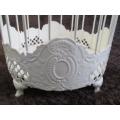 A pretty ornamental metal bird cage for your kitchen herbs or other plants