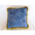 A vintage textured cushion with fluffy tassel border