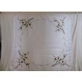 A vintage smaller size table cloth, masterfully embroidered with hand crocheted border