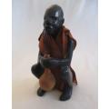 Carved wooden ethnic figurine - man drinking from guord