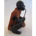 Carved wooden ethnic figurine - man drinking from guord