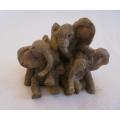 The cutest small cast stone elephant trio - clambering over each other - amazing detail