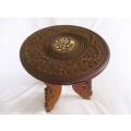 Small vintage ornately carved wooden table from India with bone inlay