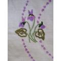 A vintage larger size expertly hand embroidered cloth with violets and hand crocheted border