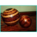 TWO WOODEN ORB DECORATIONS