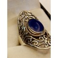 Sterling silver ladies ring with blue stone Size O.5