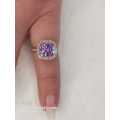 Sterling silver ladies ring with purple violet stone surrounded by cubic zirconia Size: K.5