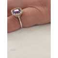 Sterling silver ladies ring with purple violet stone surrounded by cubic zirconia Size: K.5