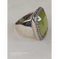 Sterling silver ladies ring with very large green stone surrounded with cubic zirconia Size: M.5
