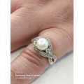 Sterling silver ladies ring with genuine pearl surrounded with cubic zirconia Size: O.5