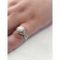 Sterling silver ladies ring with genuine pearl surrounded with cubic zirconia Size: O.5
