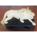 Carved Lion on a wooden Plinth - Repair on Tail