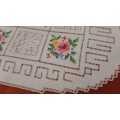 Embroidered doilie mat with cross stitch flower motifs- 29 x 18 cm