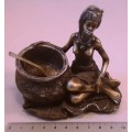 Bronze colour African lady with cooking pot and spoon