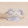 Brand new Ladies Infinity Hallmarked 925 Italy Sterling Silver Dress Ring with CZ stones.