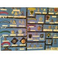 Display of South African Traditional Regiments cap/beret badges, shoulder titles and collar badges.