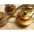 Collection of ornamental brass teapots